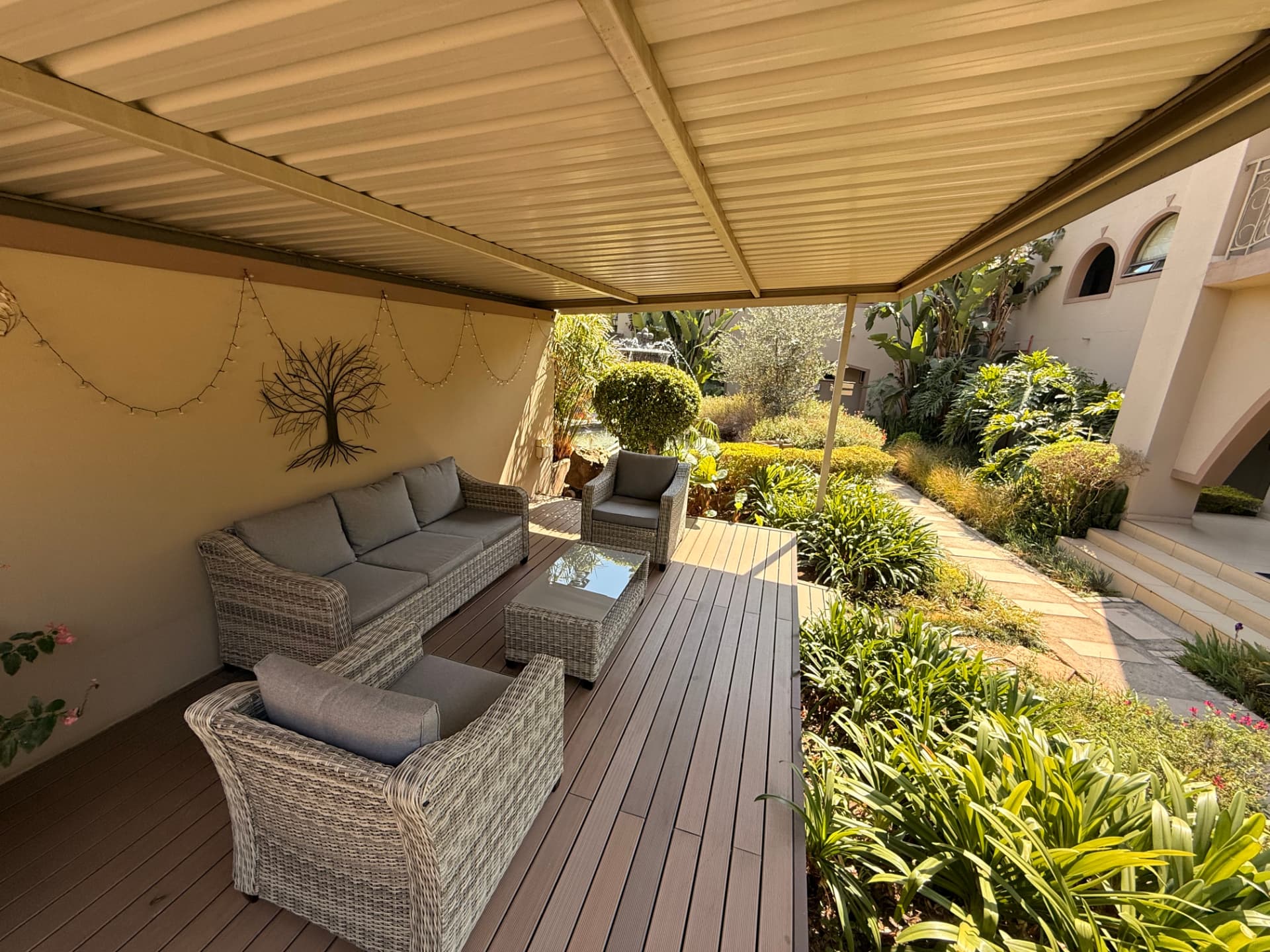 The furnished covered garden deck and path at Dunton Guest House