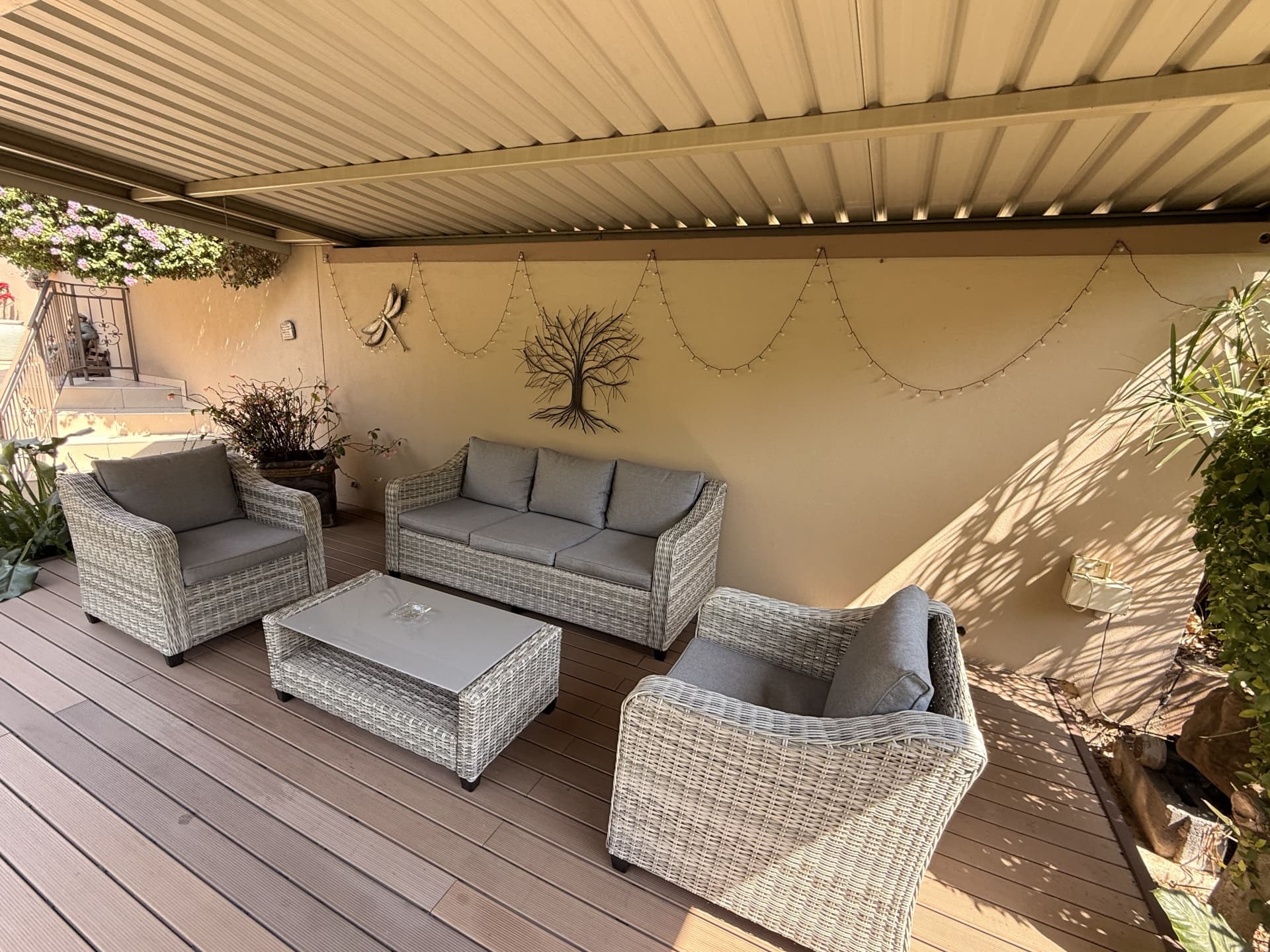 Close view of the covered garden lounge seating and wall decorations at Dunton