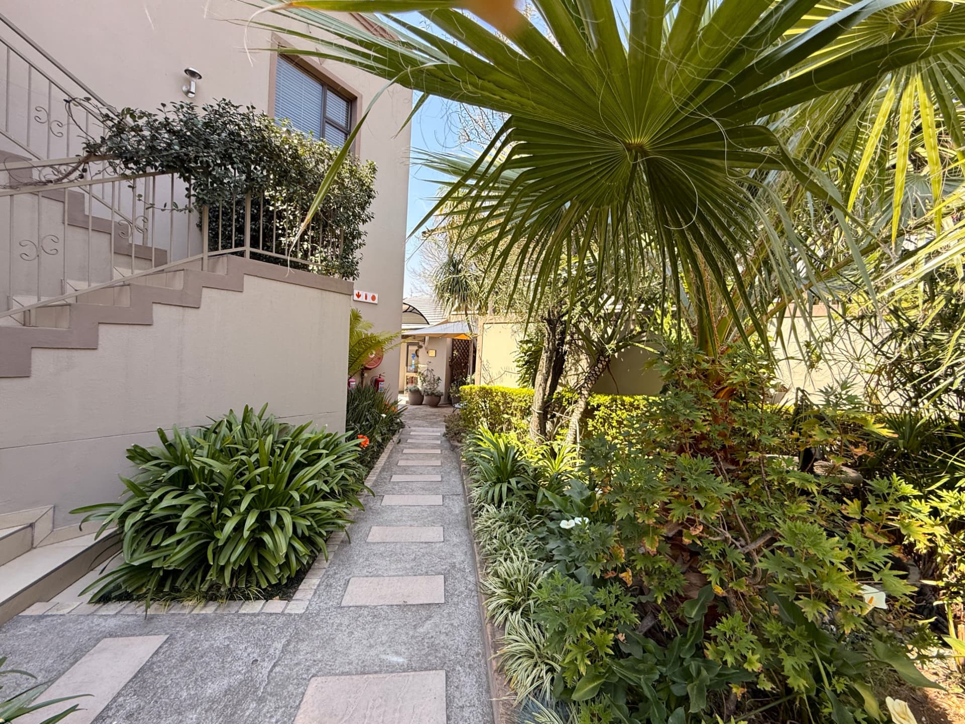 Stepping-stone path at Dunton leading past garden beds to the guest entrance