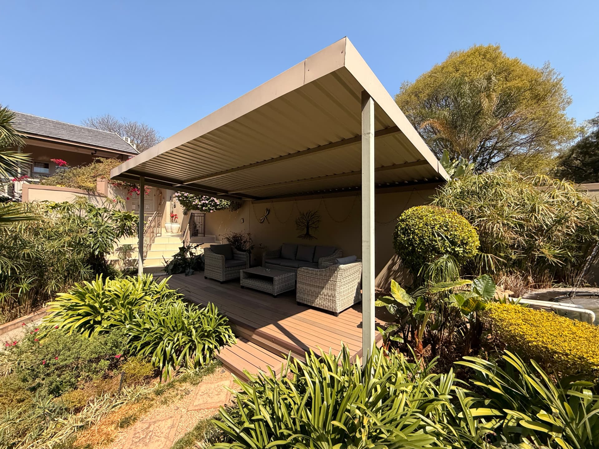 The covered garden lounge deck at Dunton, surrounded by planting