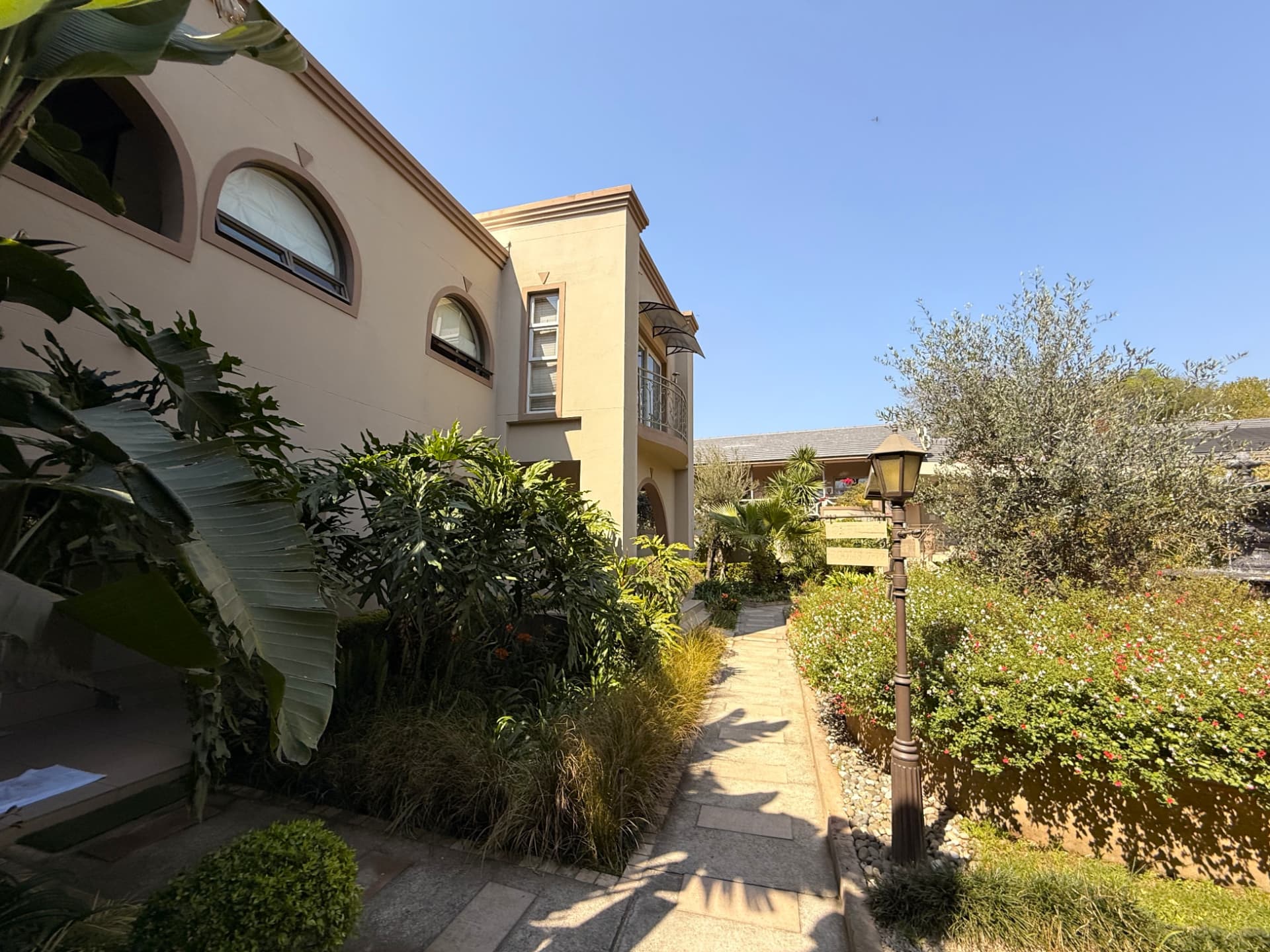 A photograph of the gardens, pool and decks at Dunton Guest House
