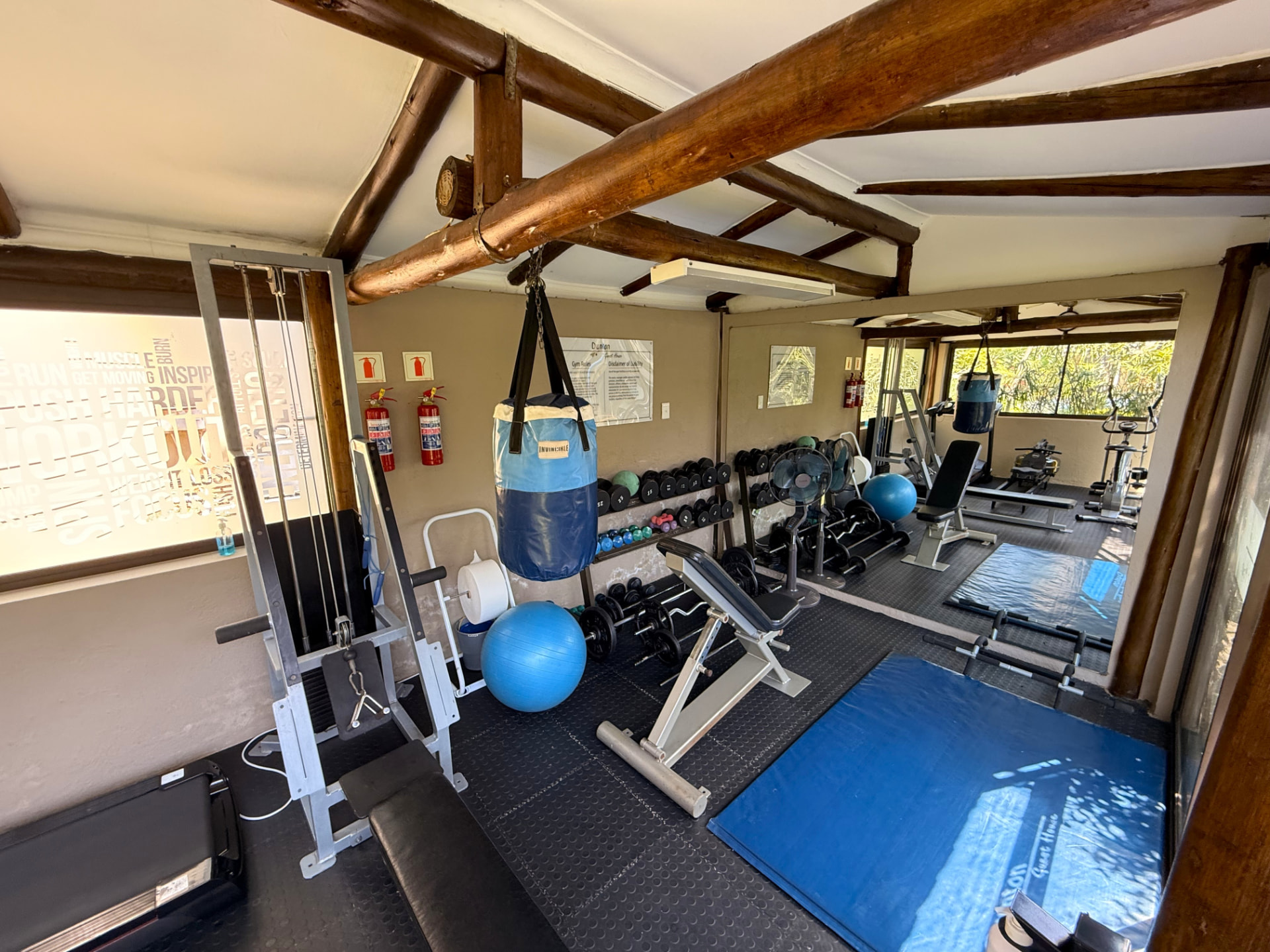 Cable and lat machine, dumbbell rack, adjustable benches, exercise balls and fans in the Dunton gym